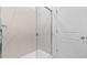 The renovated shower features floor to ceiling marble-look tile and glass doors at 23403 W Albeniz Pl, Buckeye, AZ 85326