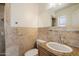 Bathroom featuring tile accents, granite counters and updated fixtures at 2436 E Elm St, Phoenix, AZ 85016