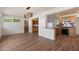 Open-concept dining area featuring wood flooring and an adjoining kitchen with wood cabinetry and granite countertops at 2436 E Elm St, Phoenix, AZ 85016