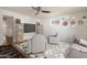 Spacious living room featuring modern furnishings, a ceiling fan, a large TV, and decor at 2436 E Elm St, Phoenix, AZ 85016