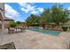 Private pool with waterfall feature and outdoor dining area for relaxing at 2926 E Minnezona Ave, Phoenix, AZ 85016