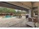 Serene backyard oasis with a waterfall pool and cozy outdoor seating at 2926 E Minnezona Ave, Phoenix, AZ 85016