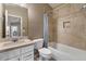 Cozy bathroom with tiled tub, shower, and white vanity at 2926 E Minnezona Ave, Phoenix, AZ 85016