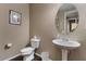 Cozy half-bathroom featuring a pedestal sink and neutral color palette at 2926 E Minnezona Ave, Phoenix, AZ 85016