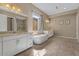 Bright bathroom with a soaking tub, dual sinks, and modern vanity at 2926 E Minnezona Ave, Phoenix, AZ 85016