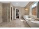Open-concept bathroom featuring a soaking tub, walk-in shower, and dual vanities at 2926 E Minnezona Ave, Phoenix, AZ 85016