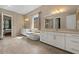 Luxurious bathroom with a soaking tub, dual vanities, and a separate toilet room at 2926 E Minnezona Ave, Phoenix, AZ 85016