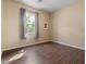 Serene bedroom featuring a large window with curtains and wood look floors at 2926 E Minnezona Ave, Phoenix, AZ 85016