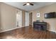 Neutral bedroom with a ceiling fan, wood floors and a piano at 2926 E Minnezona Ave, Phoenix, AZ 85016