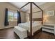 Comfortable bedroom with a four-poster bed and lots of natural light at 2926 E Minnezona Ave, Phoenix, AZ 85016