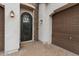 Close up of the home's entrance featuring an ornate wrought iron door and dark-stained garage door at 2926 E Minnezona Ave, Phoenix, AZ 85016