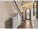 Foyer with wood flooring, wrought iron staircase, and view of a wrought iron exterior door at 2926 E Minnezona Ave, Phoenix, AZ 85016
