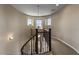 Elegant hallway with a curved staircase and a dark wood railing at 2926 E Minnezona Ave, Phoenix, AZ 85016