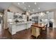 Spacious kitchen featuring white cabinets, stainless steel appliances, a large island, and adjacent dining area at 2926 E Minnezona Ave, Phoenix, AZ 85016