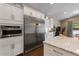 Modern kitchen features white cabinetry, stainless steel appliances, and a sleek design with plenty of storage at 2926 E Minnezona Ave, Phoenix, AZ 85016