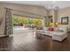 Expansive living room with sliding glass doors leading to a pool and landscaped backyard at 2926 E Minnezona Ave, Phoenix, AZ 85016