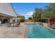 Beautiful backyard pool with waterfall feature and an outdoor dining set, perfect for entertaining guests at 2926 E Minnezona Ave, Phoenix, AZ 85016