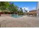 Lush backyard with a stunning pool and spa, framed by vibrant bougainvillea and mature trees at 2926 E Minnezona Ave, Phoenix, AZ 85016