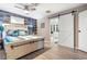 Comfortable bedroom featuring wood paneling, a sliding barn door and ensuite access to the bathroom at 3104 E Broadway Rd # 170, Mesa, AZ 85204