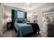 Well-lit bedroom boasts a comfortable bed, soft decor, and direct access to the Primary bath at 3104 E Broadway Rd # 170, Mesa, AZ 85204