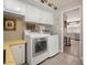 A laundry area with ample storage, and modern washer and dryer units, adjacent to the kitchen at 3104 E Broadway Rd # 170, Mesa, AZ 85204