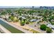 Scenic aerial of a suburban neighborhood with neatly arranged homes and the canal bordering the property at 330 W Minnezona Ave, Phoenix, AZ 85013