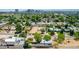 Bird's-eye view of houses amidst lush greenery and the canal, showcasing a tranquil neighborhood setting at 330 W Minnezona Ave, Phoenix, AZ 85013