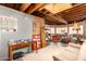 Unfinished basement space with exposed beams, drywall, and large rug with a desk at 330 W Minnezona Ave, Phoenix, AZ 85013