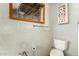 Small bathroom featuring white tiled walls, exposed plumbing, and a fire extinguisher with paper towels inside at 330 W Minnezona Ave, Phoenix, AZ 85013