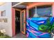 View of the side entry to the home featuring a door and art covered in graffiti at 330 W Minnezona Ave, Phoenix, AZ 85013