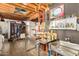 Exposed kitchen with industrial design, stainless steel countertop, open ceiling beams, and dark walls at 330 W Minnezona Ave, Phoenix, AZ 85013