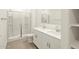 Bathroom with large glass enclosed shower, double sink vanity, and lots of storage at 35459 N Seedling St, San Tan Valley, AZ 85144