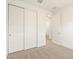 Bedroom showcasing carpet flooring, a closet, and an open doorway at 35459 N Seedling St, San Tan Valley, AZ 85144