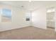 Bright bedroom featuring neutral carpet, light walls, and plenty of natural light at 35459 N Seedling St, San Tan Valley, AZ 85144