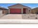 Charming single-Gathering home featuring a brick-paved driveway and a red garage door at 35459 N Seedling St, San Tan Valley, AZ 85144