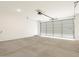 Spacious garage with concrete flooring and a roll-up door at 35459 N Seedling St, San Tan Valley, AZ 85144