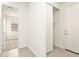 Hallway with neutral walls leads to a bedroom with carpeted flooring and a window at 35459 N Seedling St, San Tan Valley, AZ 85144