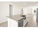 Contemporary kitchen island with stainless steel sink, dishwasher, and pendant lighting at 35459 N Seedling St, San Tan Valley, AZ 85144