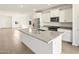 Bright and open kitchen featuring stainless steel appliances, granite countertops, and an island at 35459 N Seedling St, San Tan Valley, AZ 85144