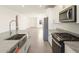 Modern kitchen with stainless steel appliances, granite countertops, and open layout at 35459 N Seedling St, San Tan Valley, AZ 85144