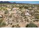 Aerial shot exhibiting horse property, facilities, desert landscape, and nearby houses in a desert community at 39606 N 3Rd Ave, Phoenix, AZ 85086
