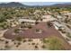 Aerial view of a sprawling desert home with circular driveway, native landscaping, and mountain views at 39606 N 3Rd Ave, Phoenix, AZ 85086