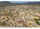 Wide aerial view of a desert community with homes, landscape, and mountain views in the distance at 39606 N 3Rd Ave, Phoenix, AZ 85086