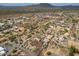 Wide aerial view of a desert community with homes, landscape, and mountain views in the distance at 39606 N 3Rd Ave, Phoenix, AZ 85086
