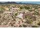 Expansive aerial view of desert home and landscape with mountain views, native trees, and circular driveway at 39606 N 3Rd Ave, Phoenix, AZ 85086