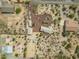 Birds-eye view of desert home with circular driveway, separate garage, horse arena, and native desert landscape at 39606 N 3Rd Ave, Phoenix, AZ 85086