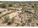 Aerial view showcases horse property, riding arena, covered stalls, and multiple buildings in a neighborhood at 39606 N 3Rd Ave, Phoenix, AZ 85086