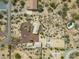 Birds-eye view of desert home with circular driveway, separate garage, horse arena, and native desert landscape at 39606 N 3Rd Ave, Phoenix, AZ 85086