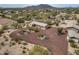 Wide aerial view showcasing the desert landscaping, circular driveway, and mountain views of the home at 39606 N 3Rd Ave, Phoenix, AZ 85086