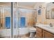 Cozy bathroom with wood cabinets, wood floors, and shower with textured glass at 39606 N 3Rd Ave, Phoenix, AZ 85086